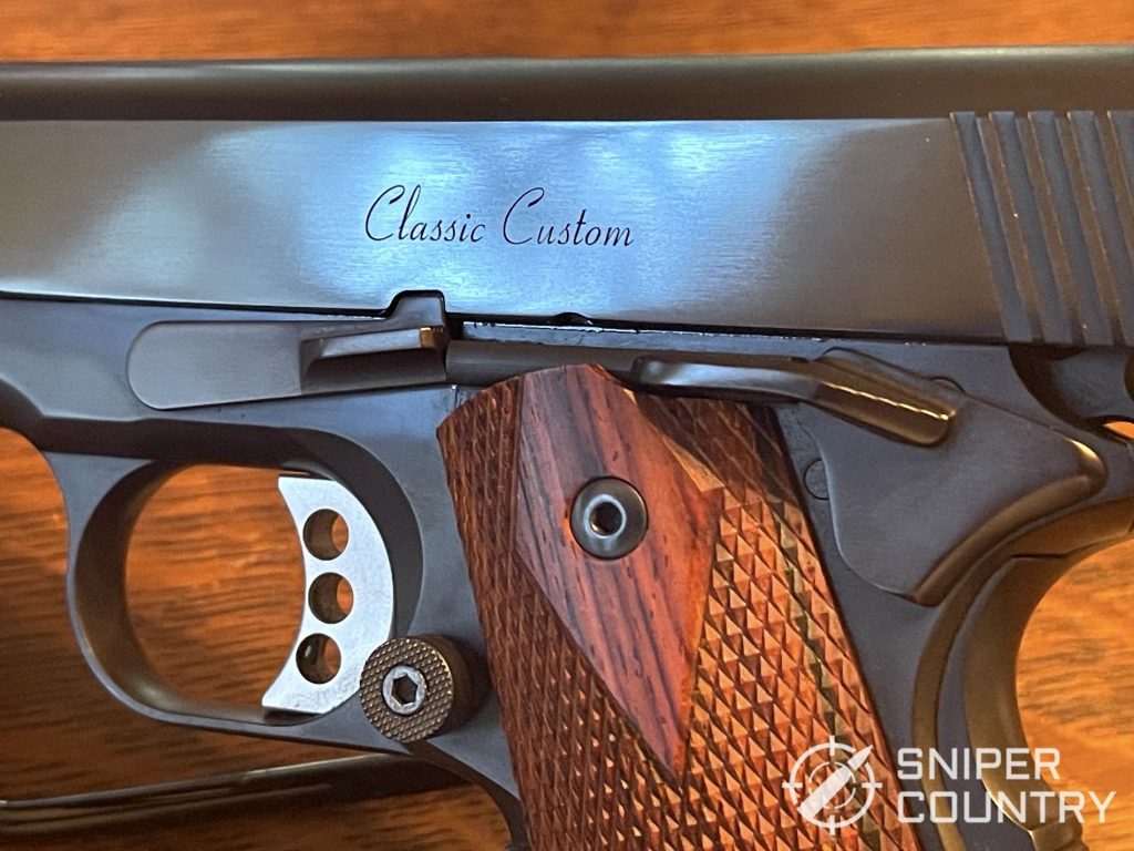 The business side of the Ed Brown Classic Custom showing the trigger, the extended magazine release, the slide stop and the safety. Ed Brownâ€™s signature three hole trigger finishes it off.