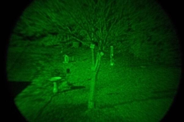 A close-up shot of a front yard using a scope with night vision.