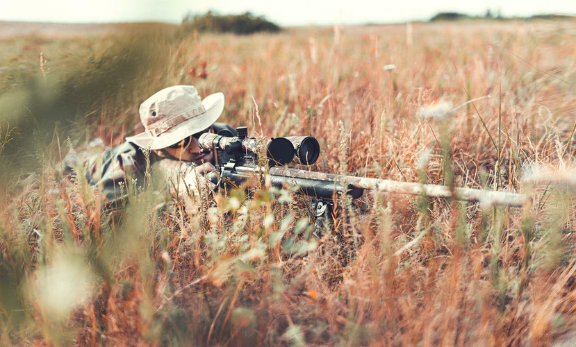 A close-up shot of an American soldier ready to shoot using his thermal scope.
