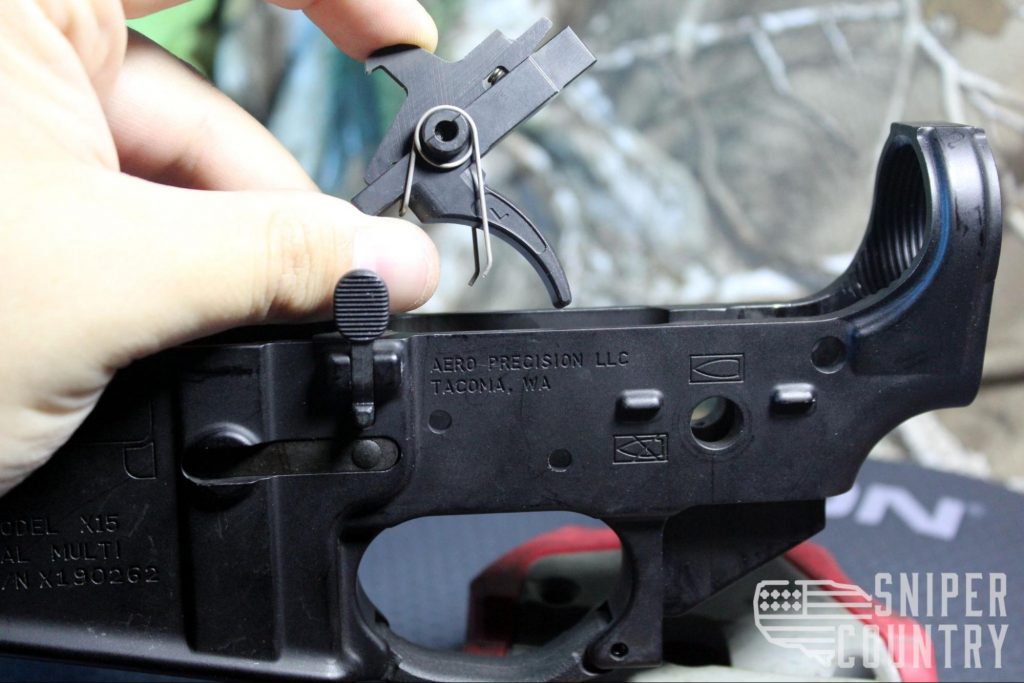 Line up the hole in the trigger with the lower